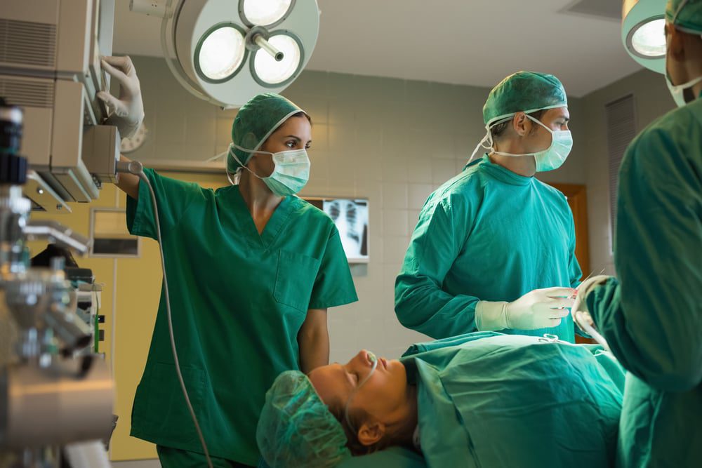 Surgeons working on a female patient in an operating theater.jpegkeepProtocol EarnFreeCashOnline